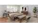 Nicely staged bedroom with warm colors, natural light, and hardwood floors at 1704 E Hackamore St, Mesa, AZ 85203