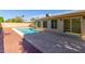 A refreshing in-ground pool is surrounded by brick pavers and a concrete patio at 1704 E Hackamore St, Mesa, AZ 85203