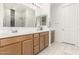 Bathroom featuring double sinks, modern fixtures, and a shower with decorative tile at 1736 E Joelle Dr, Casa Grande, AZ 85122