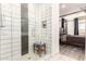 Bathroom shower featuring modern white tiles and a gray accent stripe at 1736 E Joelle Dr, Casa Grande, AZ 85122