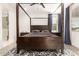 Bedroom featuring a four poster bed, neutral walls, accent rug, and large window at 1736 E Joelle Dr, Casa Grande, AZ 85122