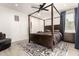 Bedroom featuring a four poster bed, neutral walls, accent rug, and a ceiling fan for comfort at 1736 E Joelle Dr, Casa Grande, AZ 85122