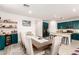 Open-concept dining area with a large table, stylish décor, and seamless flow to the kitchen at 1736 E Joelle Dr, Casa Grande, AZ 85122