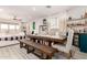Open-concept dining area with a large table, stylish décor, and seamless flow to the living room at 1736 E Joelle Dr, Casa Grande, AZ 85122