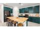 Bright kitchen boasts teal cabinets, stainless steel appliances, and butcher block island with seating at 1736 E Joelle Dr, Casa Grande, AZ 85122