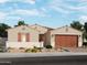 Charming single-story home with a well-manicured front yard and an attached two-car garage at 17679 W Mariposa Dr, Goodyear, AZ 85395