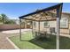 Relaxing backyard space with a gazebo, outdoor seating, and well-maintained artificial grass at 17789 W Bridger St, Surprise, AZ 85388