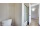 Bright bathroom featuring a toilet, a tiled shower with glass doors, and neutral wall colors at 17789 W Bridger St, Surprise, AZ 85388