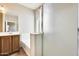 Bathroom featuring a vanity, a bathtub with glass enclosure, and neutral paint at 17789 W Bridger St, Surprise, AZ 85388