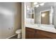 Bathroom features a single sink vanity, mirror, and a toilet at 17789 W Bridger St, Surprise, AZ 85388