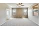 Spacious bedroom with neutral carpet, a ceiling fan, and two windows at 17789 W Bridger St, Surprise, AZ 85388