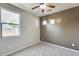 Neutral bedroom with a large window, carpet flooring, and ample natural light at 17789 W Bridger St, Surprise, AZ 85388