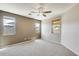 Bright bedroom with plush carpet, ceiling fan, and two-tone neutral paint at 17789 W Bridger St, Surprise, AZ 85388