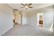 Bedroom with carpet, ceiling fan, and doorways to other rooms and a bathroom at 17789 W Bridger St, Surprise, AZ 85388