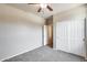 Bright bedroom featuring neutral walls, carpet, ceiling fan, and closet for ample storage at 17789 W Bridger St, Surprise, AZ 85388