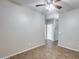 Comfortable bedroom with tile flooring, neutral walls, ceiling fan, and an open doorway to hall at 17789 W Bridger St, Surprise, AZ 85388