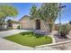 Charming home with a well-manicured front yard, mature tree, and a two-car garage at 17789 W Bridger St, Surprise, AZ 85388
