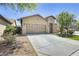Single-story home featuring desert landscaping, a two-car garage, and a welcoming entryway at 17789 W Bridger St, Surprise, AZ 85388