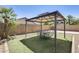 A backyard featuring a charming gazebo, turf, and desert landscaping at 17789 W Bridger St, Surprise, AZ 85388