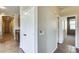 Hallway with tile flooring showing access to bathroom, bedroom, closet and kitchen at 17789 W Bridger St, Surprise, AZ 85388