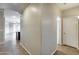 Bright hallway with tile flooring leading to various rooms in the home at 17789 W Bridger St, Surprise, AZ 85388