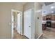 Hallway with tile flooring, showing access to the kitchen, a bathroom, and additional living spaces at 17789 W Bridger St, Surprise, AZ 85388