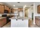 Well-lit kitchen featuring granite countertops, a kitchen island, and plenty of cabinet space at 17789 W Bridger St, Surprise, AZ 85388