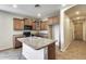 Open kitchen layout with island, wood cabinets, and modern appliances at 17789 W Bridger St, Surprise, AZ 85388