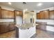 Kitchen with wood cabinets, kitchen island and ample storage at 17789 W Bridger St, Surprise, AZ 85388