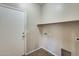 Convenient laundry room with shelving, washer and dryer hookups, and a door for easy access at 17789 W Bridger St, Surprise, AZ 85388