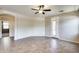 Bright and airy living room with neutral walls, ceiling fan, and tile flooring throughout at 17789 W Bridger St, Surprise, AZ 85388