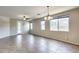 Bright living room with tiled flooring and natural light from large windows at 17789 W Bridger St, Surprise, AZ 85388