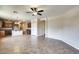 Inviting living area with tile floors, connecting to the kitchen, and ceiling fan for added comfort at 17789 W Bridger St, Surprise, AZ 85388