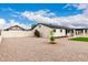 Expansive backyard with gravel landscaping, mature trees, and a covered parking area at 1852 N Grand St, Mesa, AZ 85201