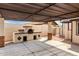 Covered backyard patio features a custom brick oven, great for outdoor entertaining at 1852 N Grand St, Mesa, AZ 85201