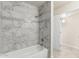 Updated bathroom with marble tiled shower and tub combination at 1852 N Grand St, Mesa, AZ 85201
