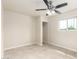 This bedroom features neutral walls, tile flooring, a window and a closet at 1852 N Grand St, Mesa, AZ 85201
