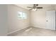 This bedroom features neutral walls, tile flooring, a window and a door at 1852 N Grand St, Mesa, AZ 85201