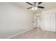 Bright bedroom with closet space featuring ceiling fan and neutral colored walls at 1852 N Grand St, Mesa, AZ 85201