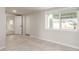 Sunlit bedroom with tile flooring, a window view, and convenient closet space at 1852 N Grand St, Mesa, AZ 85201