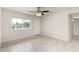 Bright bedroom with tile flooring, ceiling fan, and a window view of the front yard at 1852 N Grand St, Mesa, AZ 85201