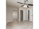 Neutral bedroom featuring a ceiling fan, tile floors, and closet space at 1852 N Grand St, Mesa, AZ 85201