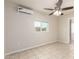 Spacious bedroom with a ceiling fan, cooling unit and tiled floors at 1852 N Grand St, Mesa, AZ 85201