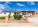 Ranch-style house with a covered parking area, gravel front yard, and black iron fence at 1852 N Grand St, Mesa, AZ 85201