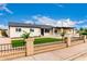 Charming single-story home with brick fence, gravel yard, and green turf in front of house at 1852 N Grand St, Mesa, AZ 85201