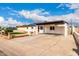 Single-story home featuring a covered parking area, gravel yard, and desert landscaping at 1852 N Grand St, Mesa, AZ 85201