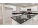 Modern kitchen with white cabinetry, stainless steel appliances, and a gray granite island at 1852 N Grand St, Mesa, AZ 85201