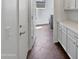Hallway featuring a washing machine, dryer, and white cabinets at 19973 E Thornton Rd, Queen Creek, AZ 85142