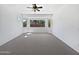 Empty main bedroom showcasing a bay window, ceiling fan, and carpet flooring at 19973 E Thornton Rd, Queen Creek, AZ 85142
