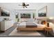 Comfortable main bedroom with a bay window, ceiling fan, and neutral colored walls at 19973 E Thornton Rd, Queen Creek, AZ 85142